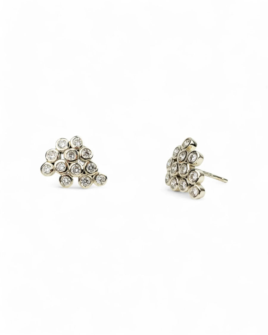 White gold cluster stud earrings with round bezel-set diamonds on white background