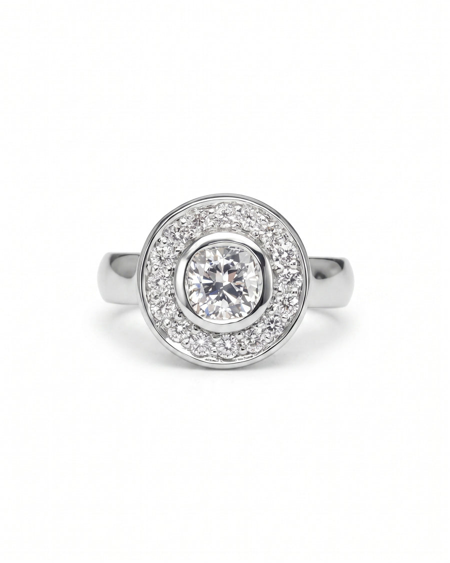 Silver engagement ring with a round diamond cluster design.