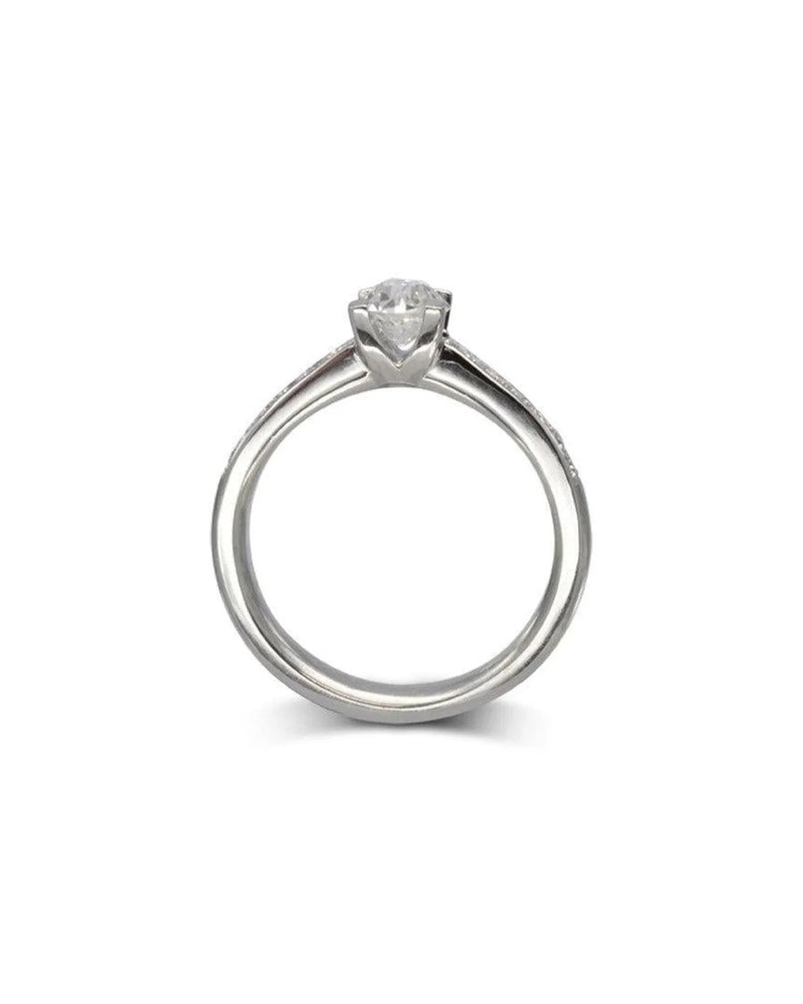 Silver engagement ring with a round diamond center stone and diamond shoulder accents.