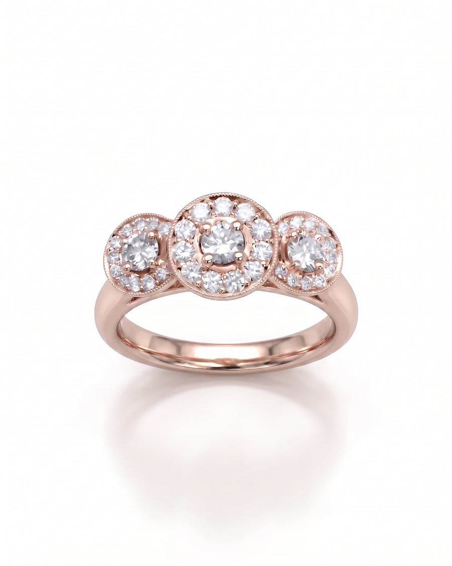 Rose gold trilogy engagement ring featuring three round diamond cluster settings with milgrain detailing.