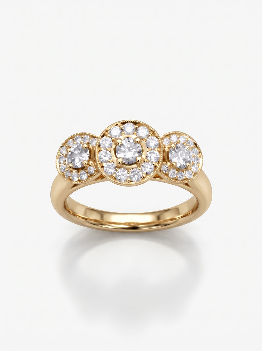 Gold trilogy engagement ring featuring three round diamond cluster settings with milgrain detailing on a polished band.