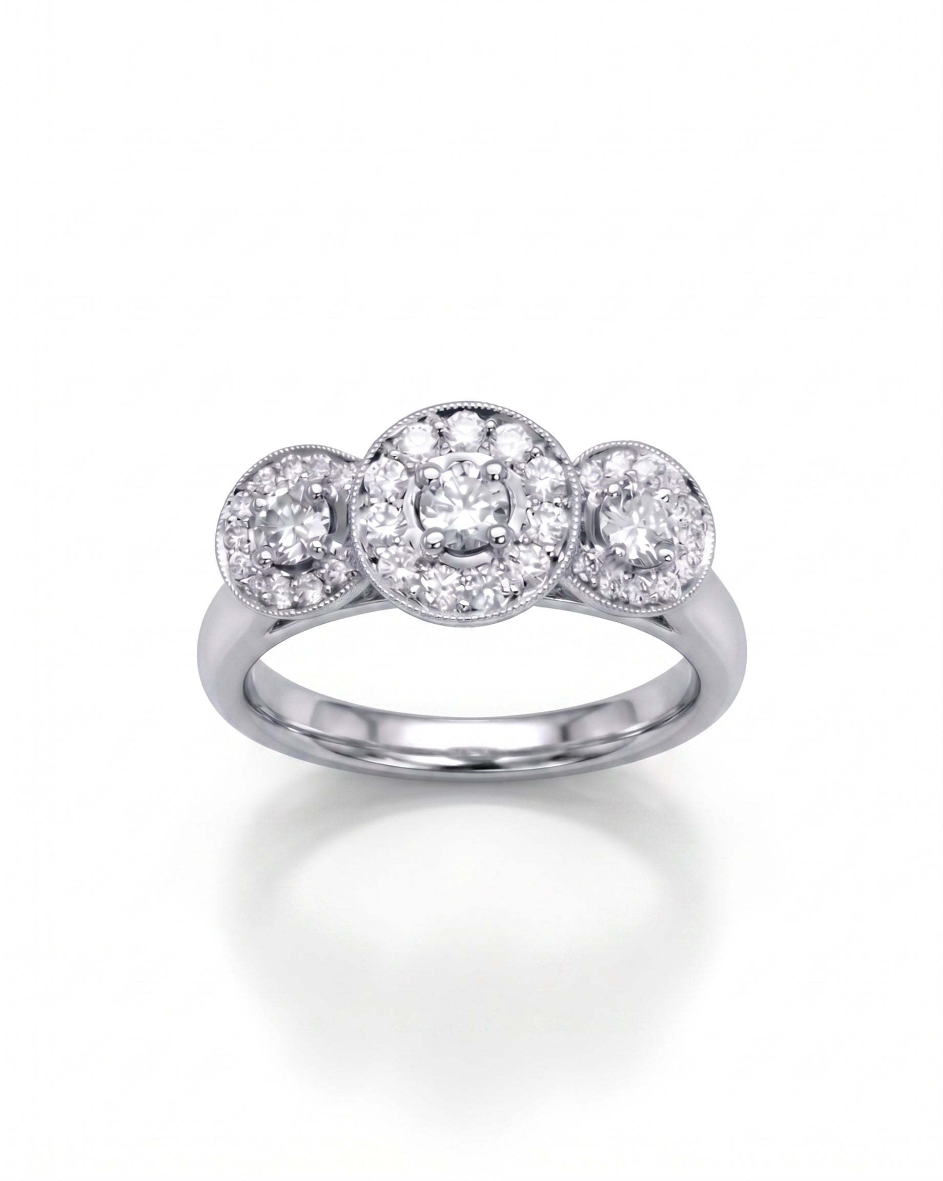 White gold trilogy cluster engagement ring with round diamonds.