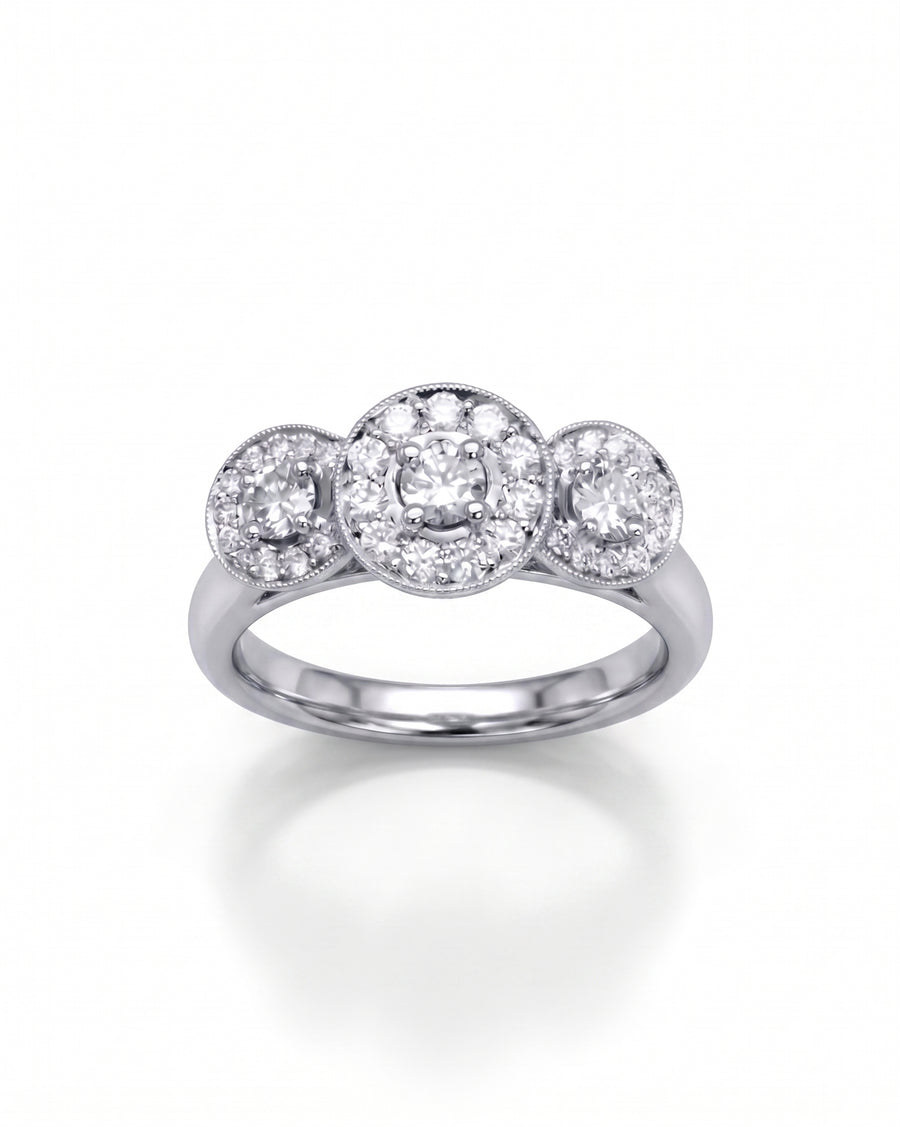 White gold trilogy cluster engagement ring with round diamonds.