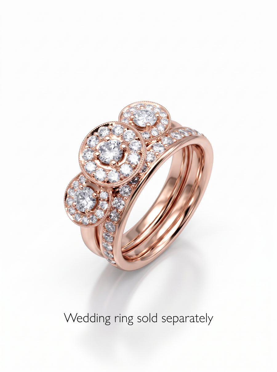 Rose gold trilogy engagement ring featuring three diamond cluster settings and a pavé band.