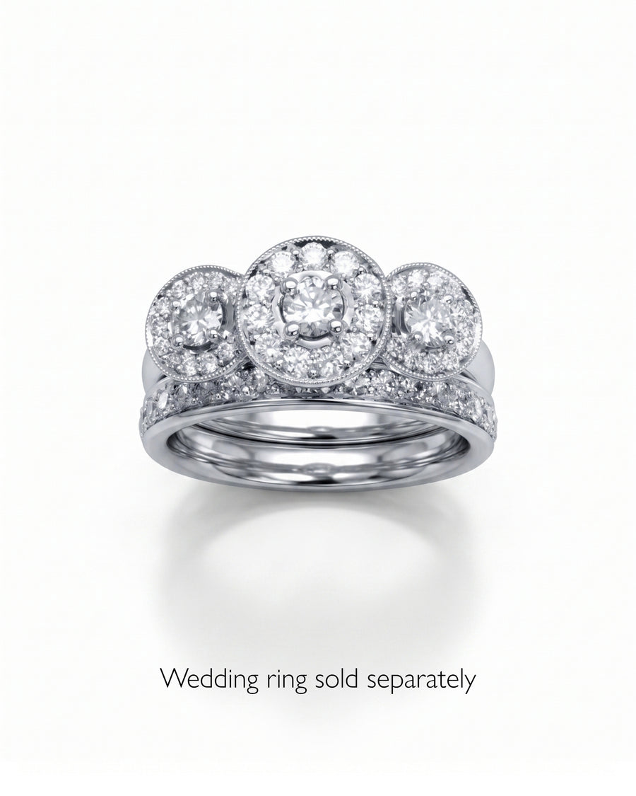 White gold diamond trilogy cluster engagement ring with a matching diamond band.