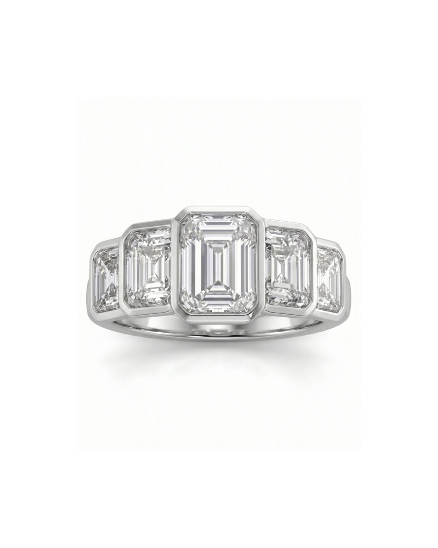 White gold ring with five emerald cut diamonds.