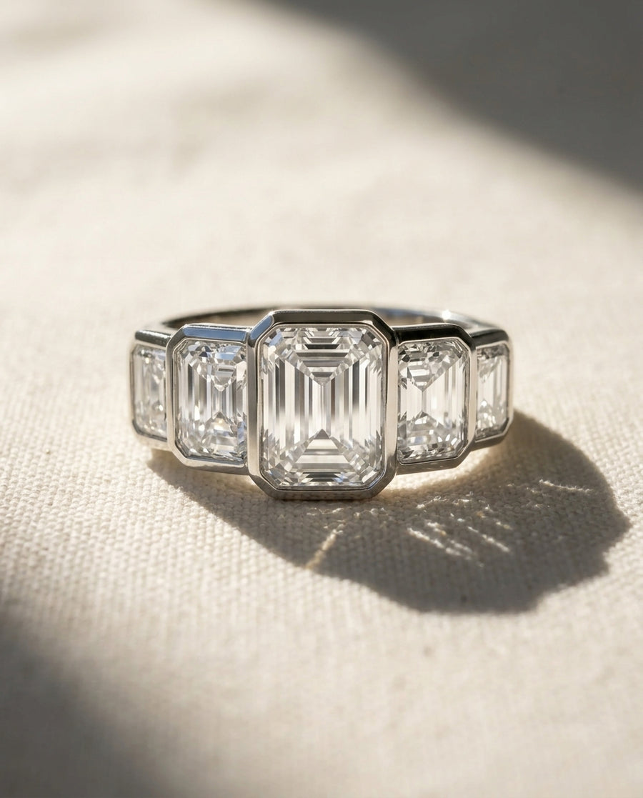 Platinum five-diamond ring with emerald cut lab grown diamonds.