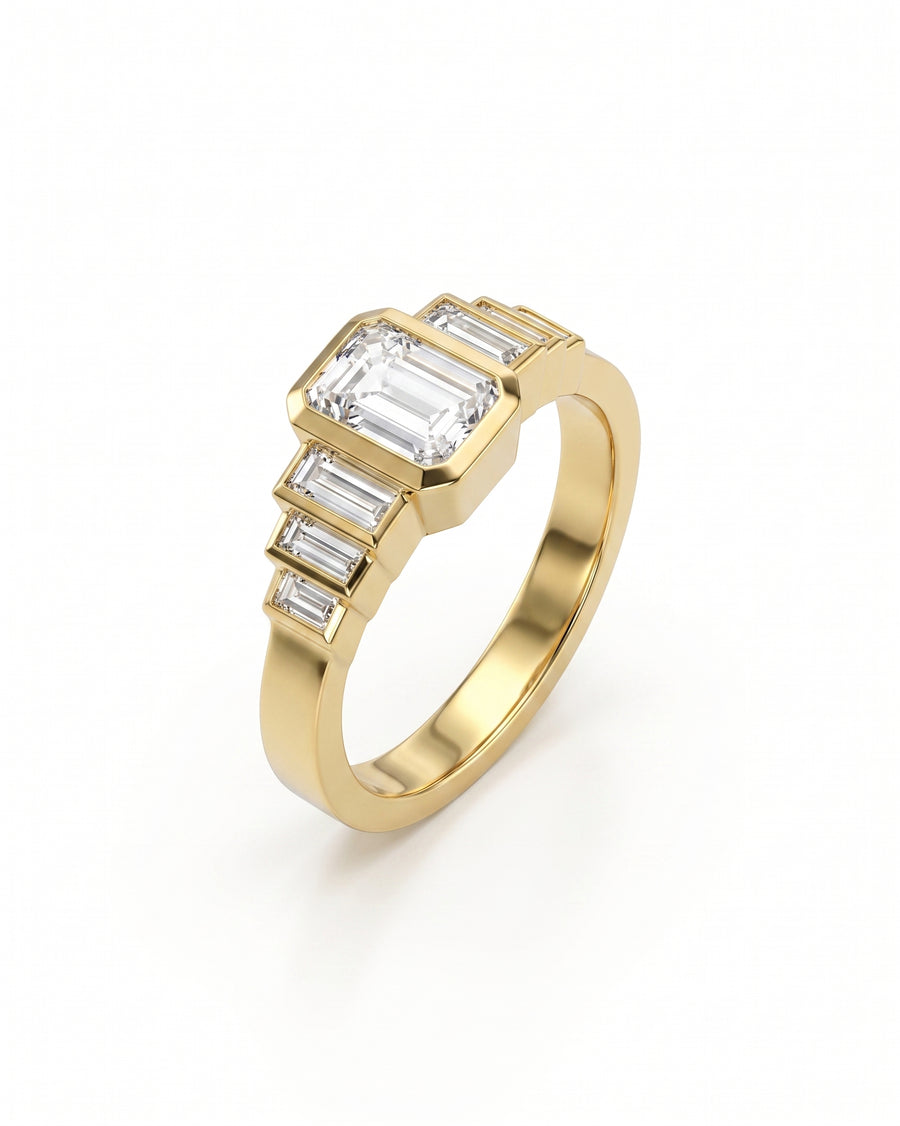 Gold engagement ring with an emerald cut diamond and six baguette diamonds.