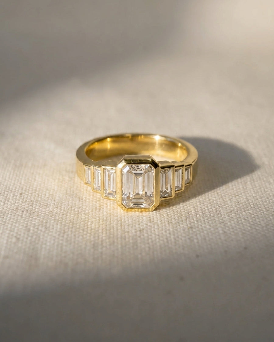 18ct yellow gold emerald cut seven diamond engagement ring.