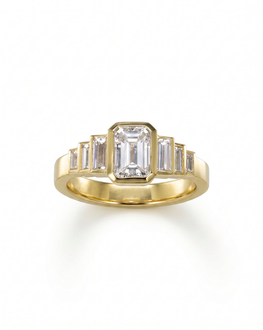 Gold Art Deco engagement ring with an emerald cut diamond and six baguette diamonds.