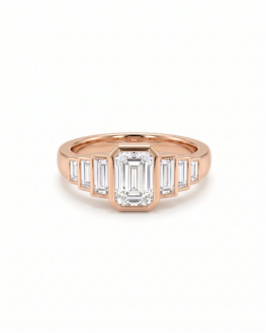 Rose gold engagement ring featuring an emerald cut center diamond flanked by six baguette cut diamonds.