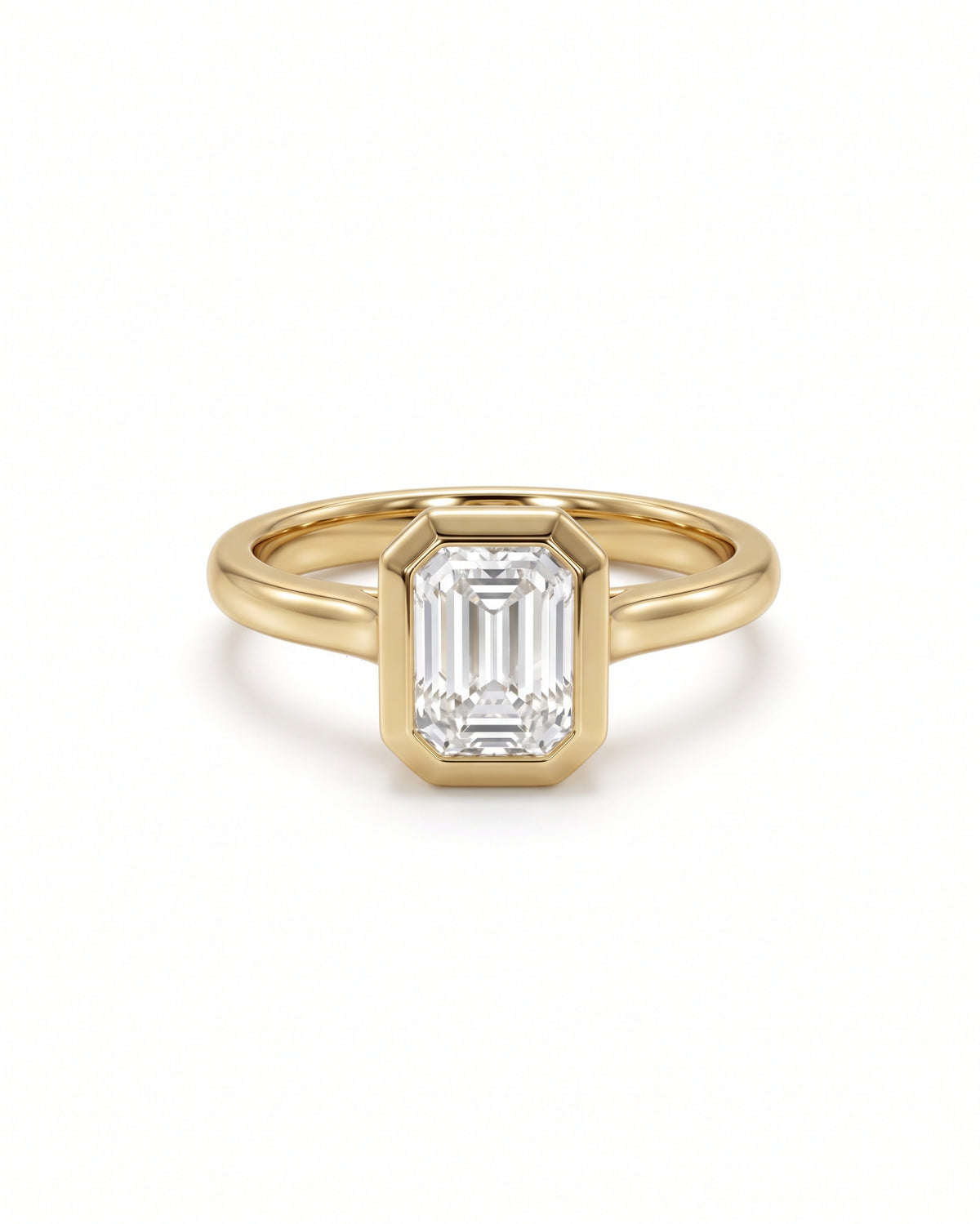 Emerald cut diamond engagement ring in 18ct yellow gold with a bezel setting and cathedral band.