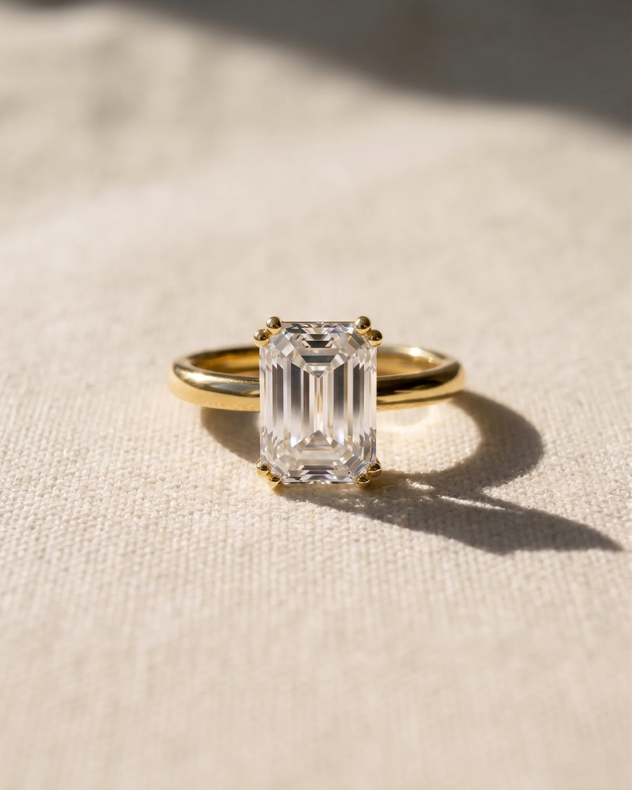 18ct yellow gold engagement ring with a 1ct emerald cut lab grown diamond.
