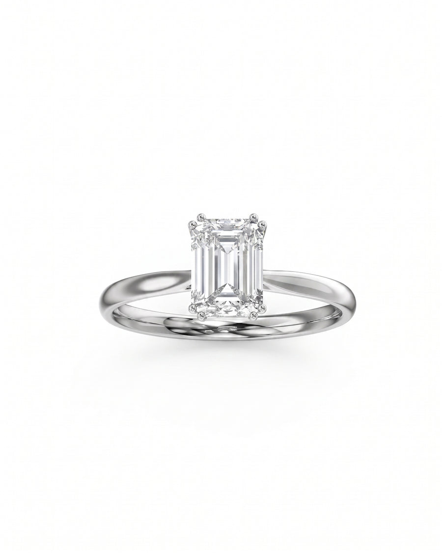 Platinum engagement ring with an emerald cut diamond and hidden halo.