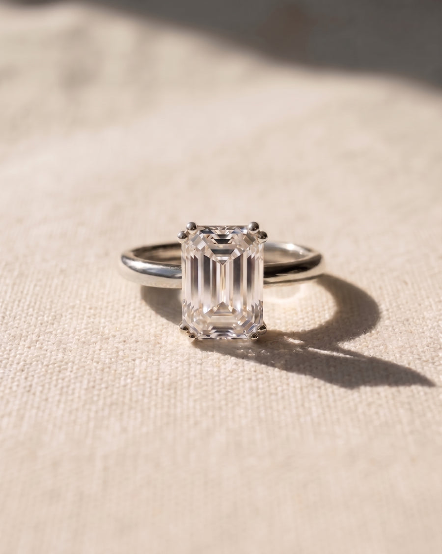 Platinum emerald cut hidden halo engagement ring with a 1ct lab grown diamond.