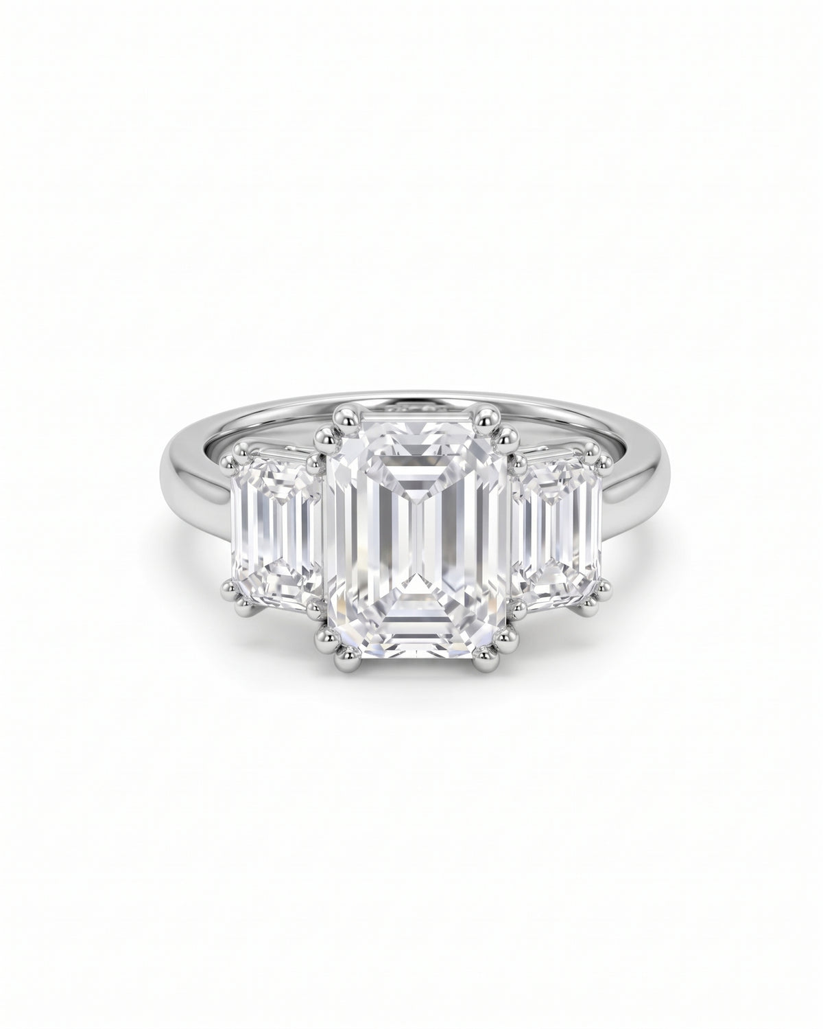 Platinum trilogy engagement ring featuring three emerald-cut diamonds on a polished band.