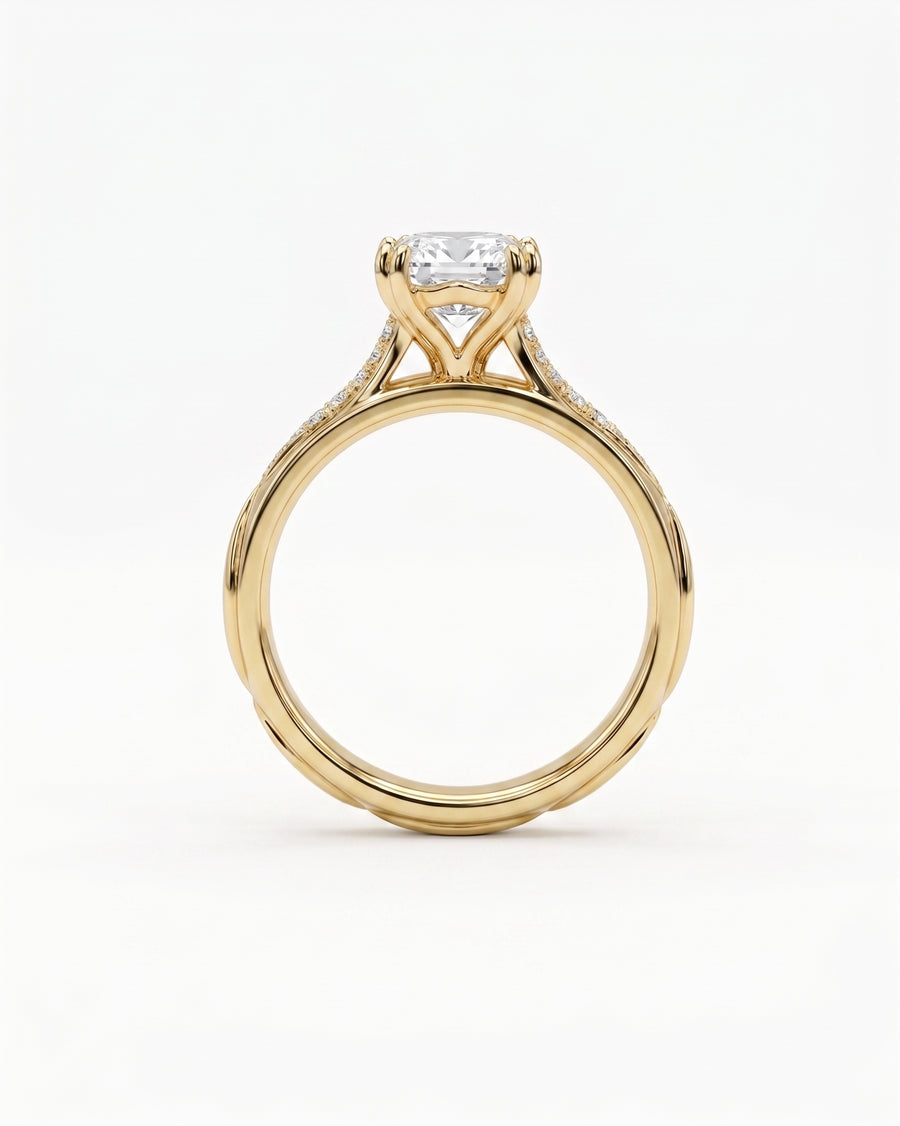 Gold engagement ring with a cushion-cut diamond and pavé band.