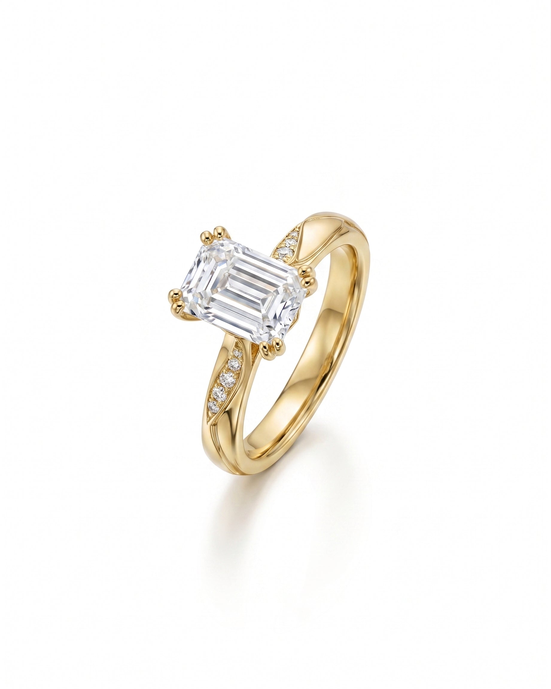 yellow Gold engagement ring with an emerald cut diamond and pavé accents.