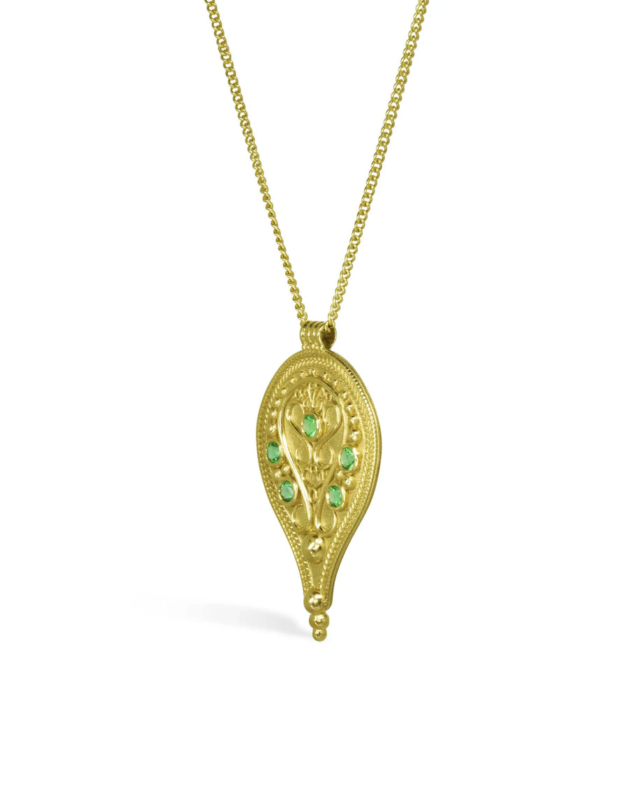 Ornate gold filigree pendant necklace with green emerald gemstones on a white background