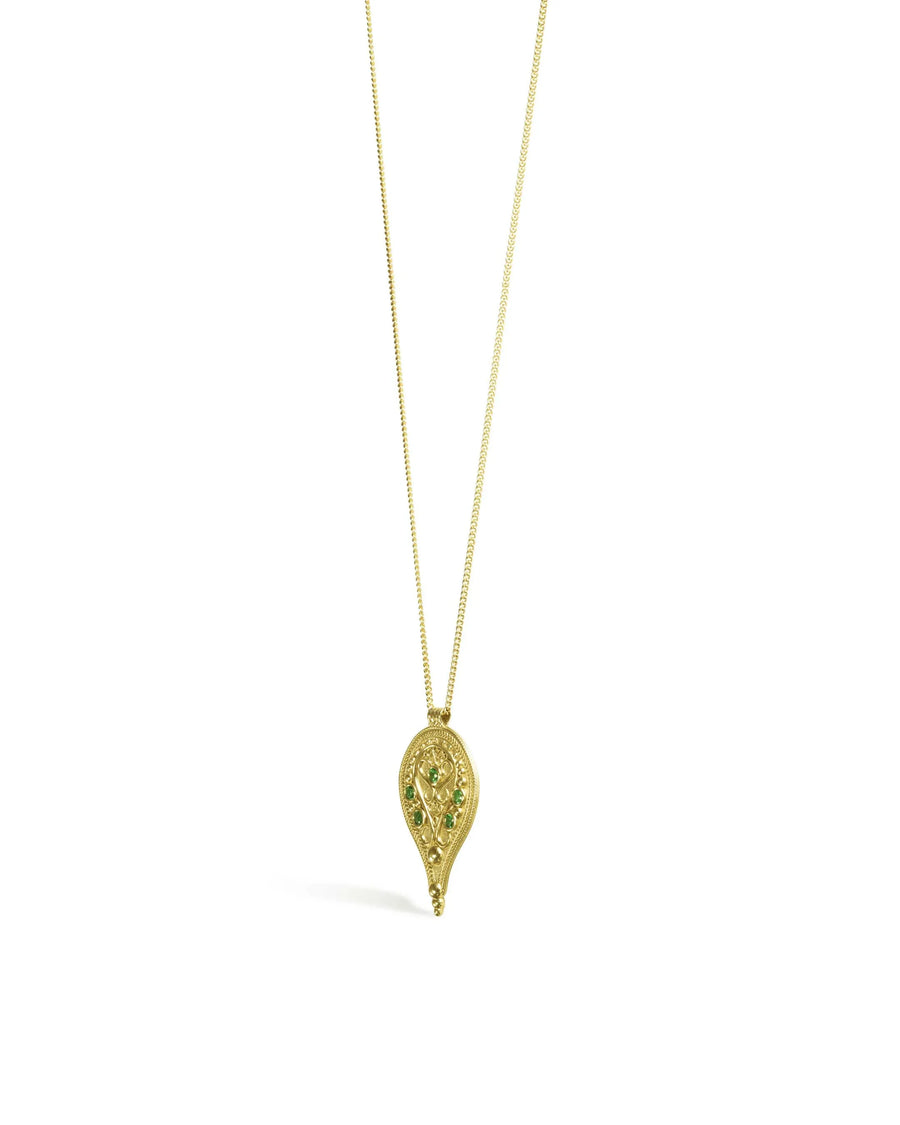 Gold filigree pendant necklace with green emerald stones on a white background