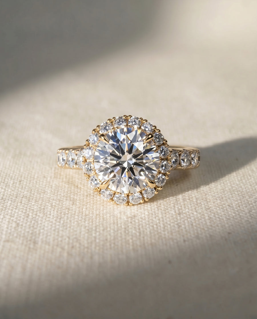 18ct yellow gold engagement ring with a round lab grown diamond and diamond halo.
