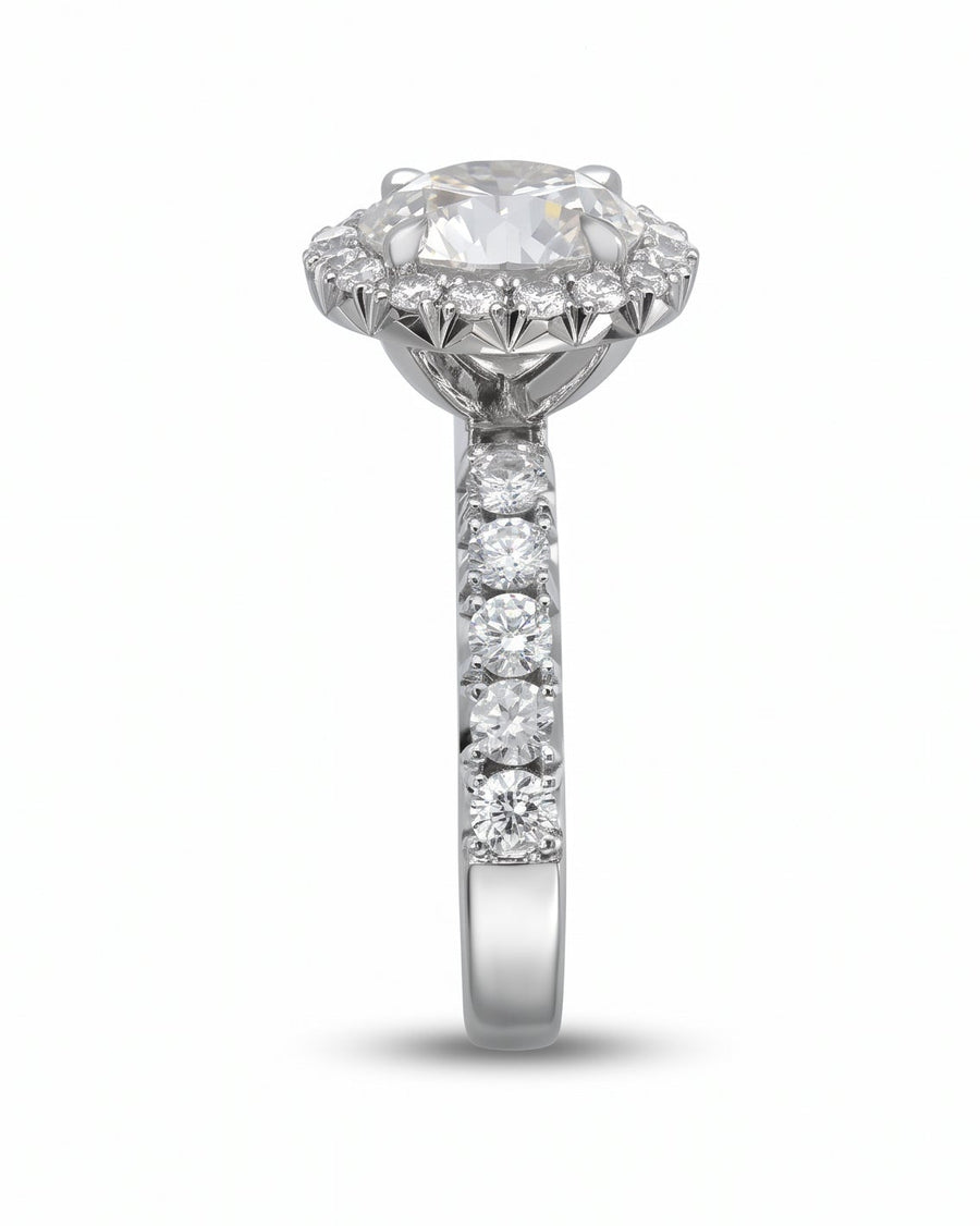 Silver fish tail set cluster engagement ring with round diamonds.