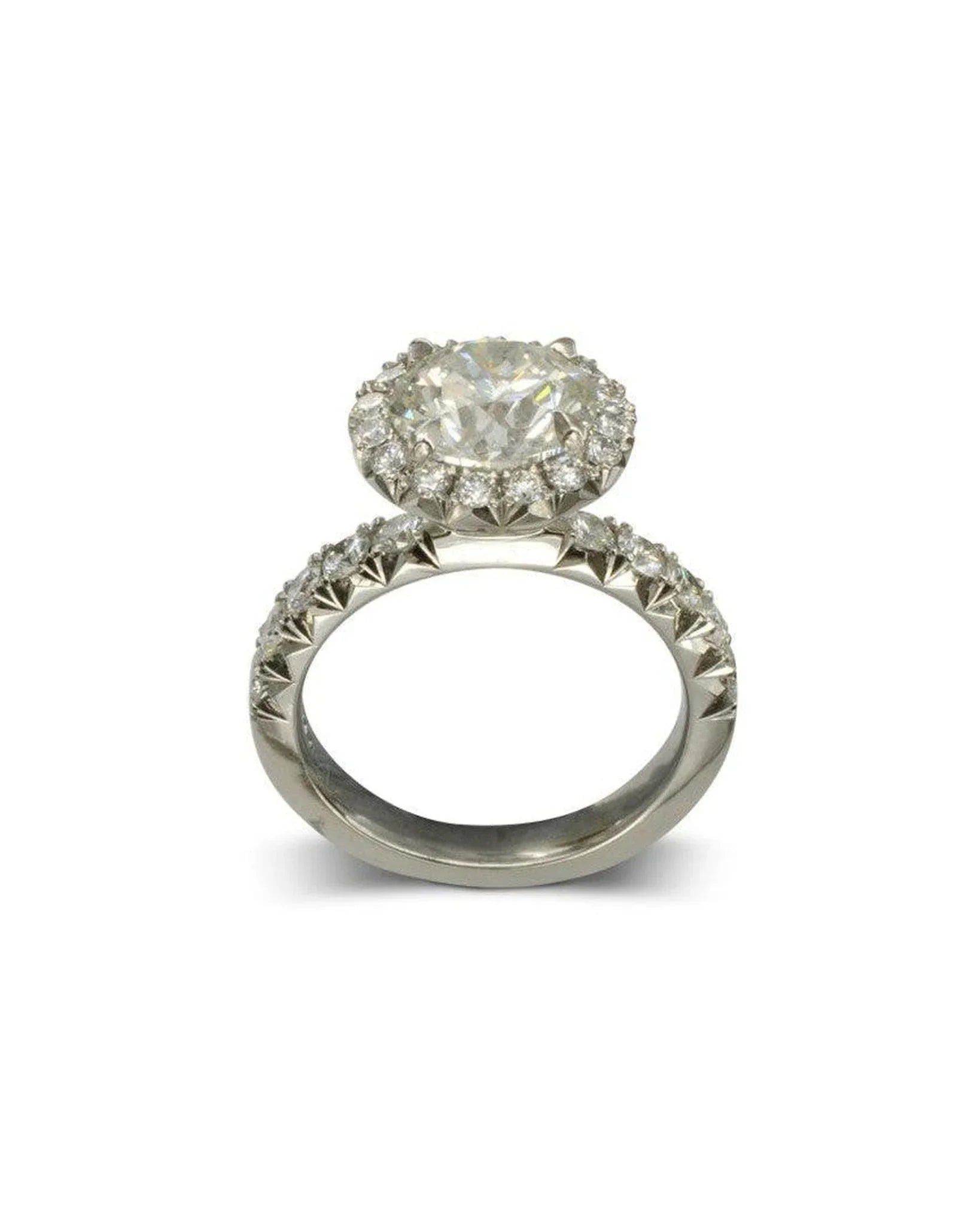 Platinum ring with fish tail setting, featuring a round emerald-cut cluster and diamond detailing