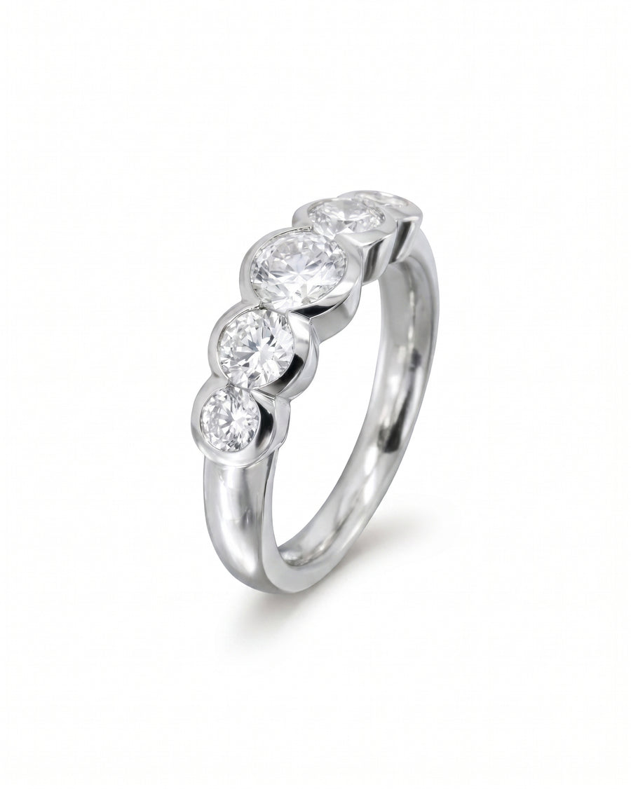 Silver eternity ring with five round brilliant cut diamonds.