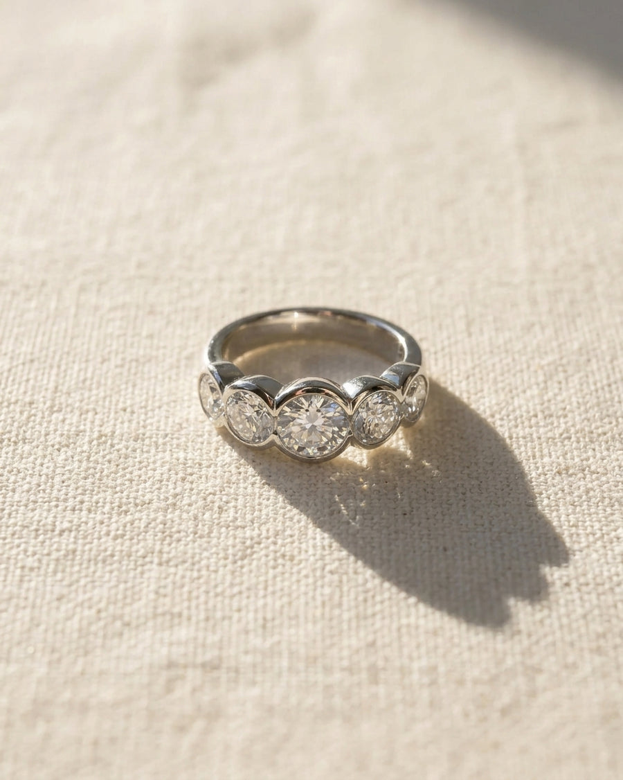 Silver eternity ring with five round brilliant cut diamonds.