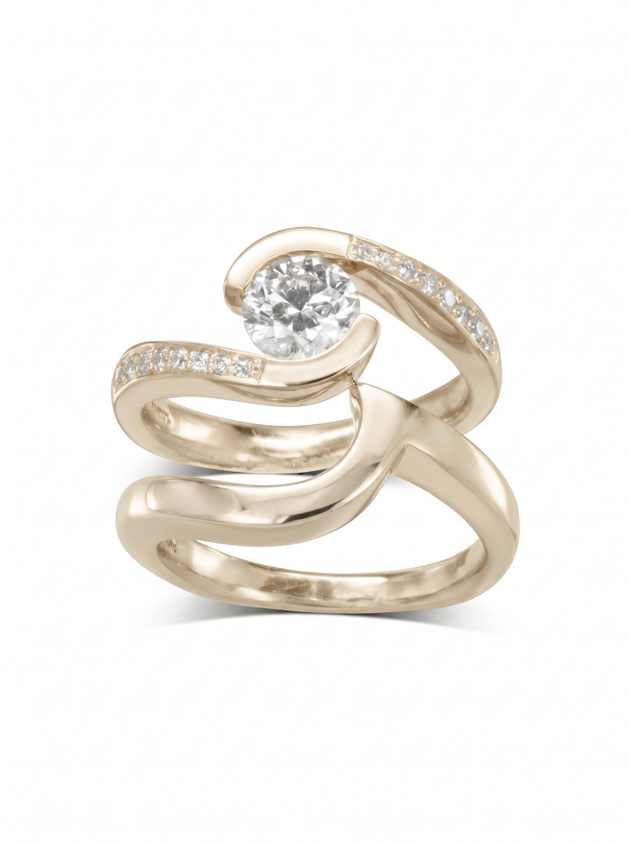 Yellow gold engagement and wedding band set with a round diamond and pavé accents in a flat twist design.