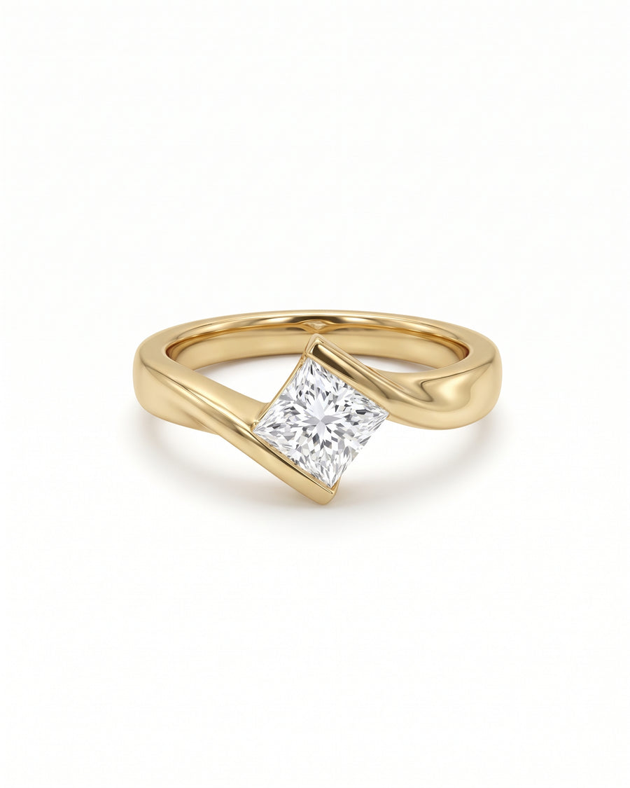 Princess cut diamond engagement ring with a flat twist yellow gold band on a white background.