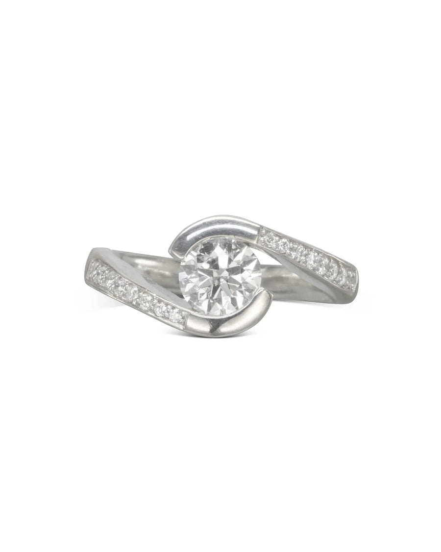 Yellow gold flat twist engagement ring with a round diamond and pavé accents.