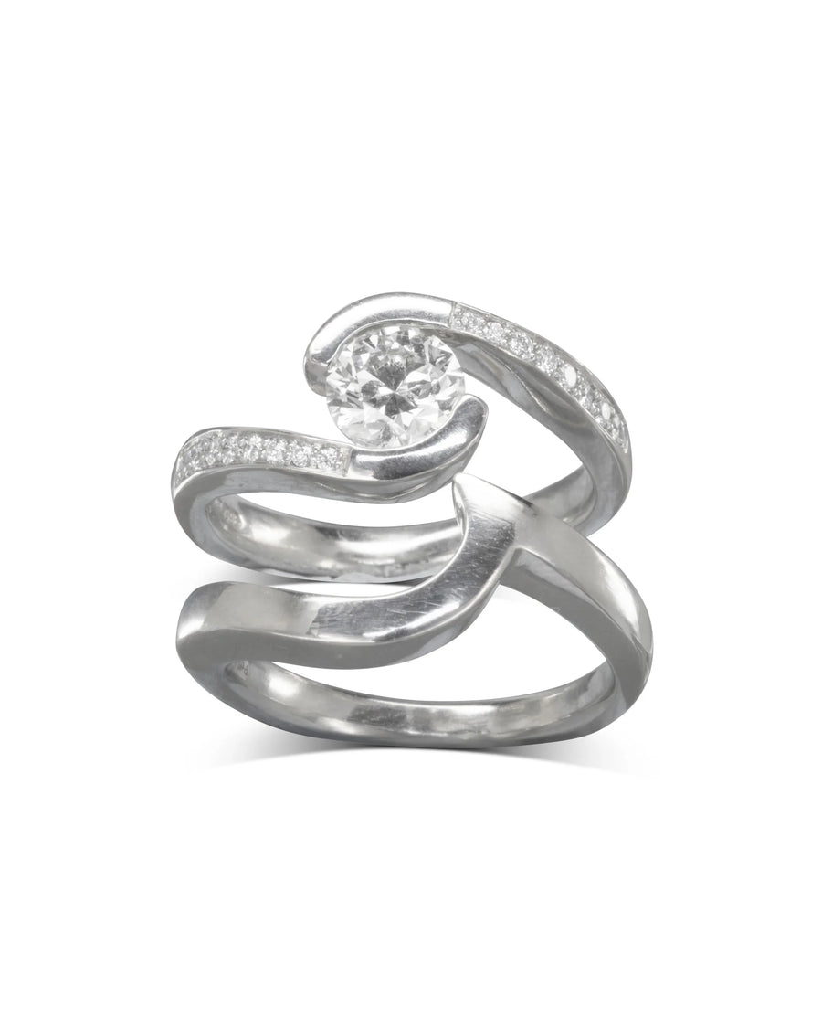 Yellow gold flat twist engagement ring with a round diamond and pavé accents.
