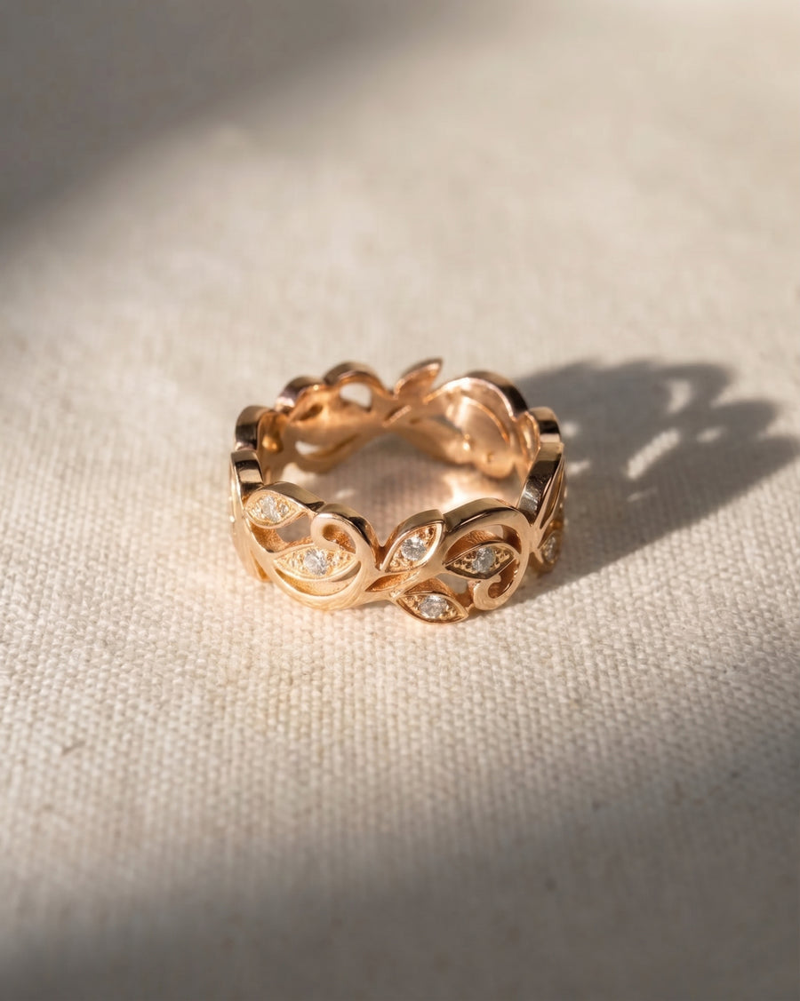 18ct rose gold floral diamond ring with leaf-shaped accents.