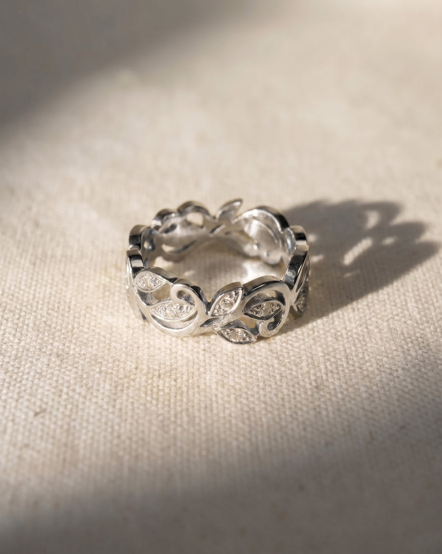 Platinum floral diamond ring with an openwork leaf design.