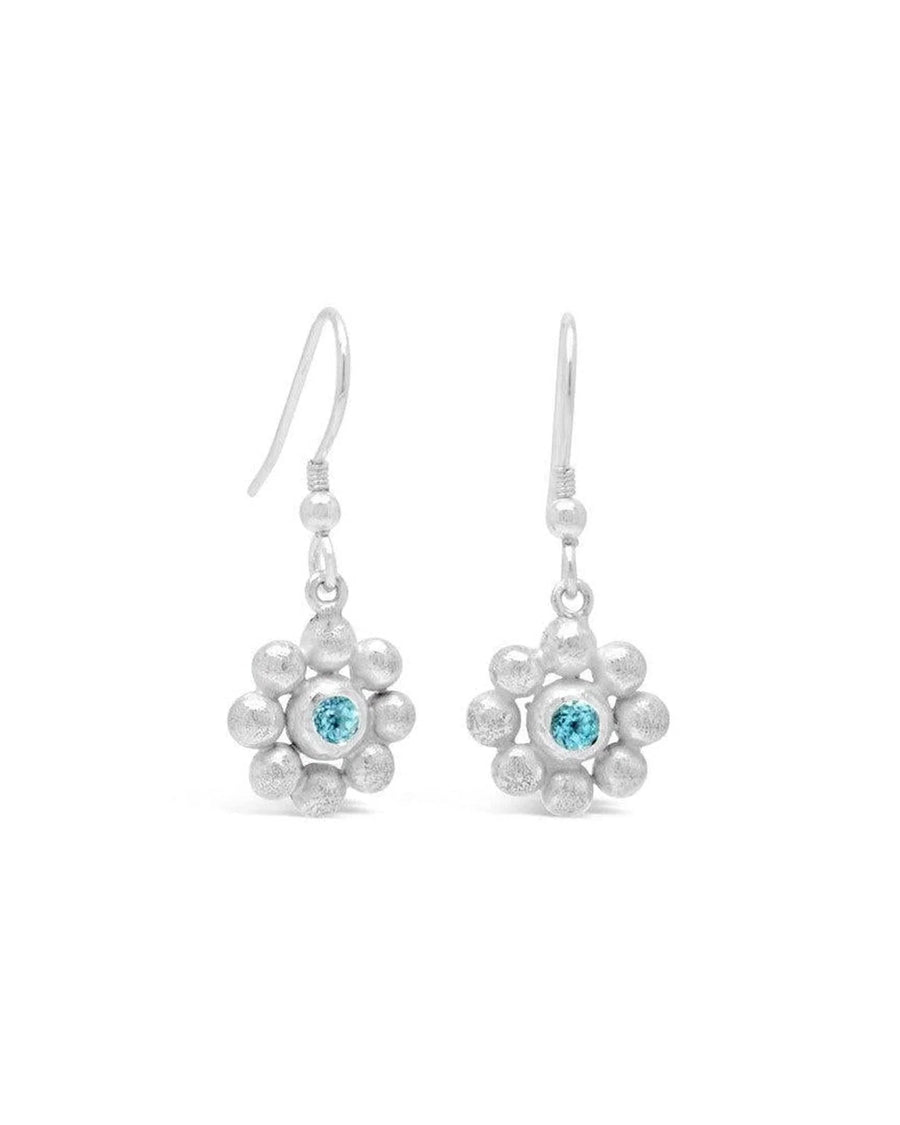 Silver drop earrings featuring a textured flower design with a central pale blue sky blue topaz gemstone.