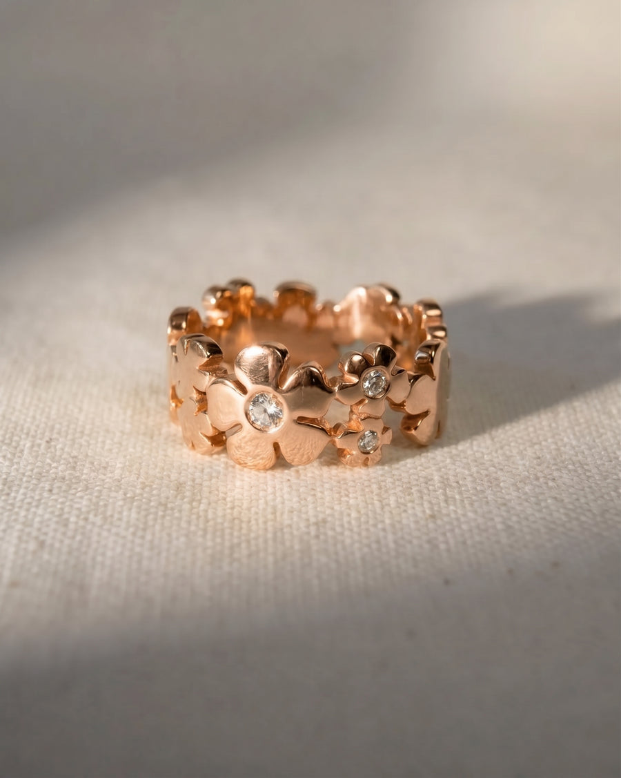 Rose gold flower eternity ring with small diamonds.