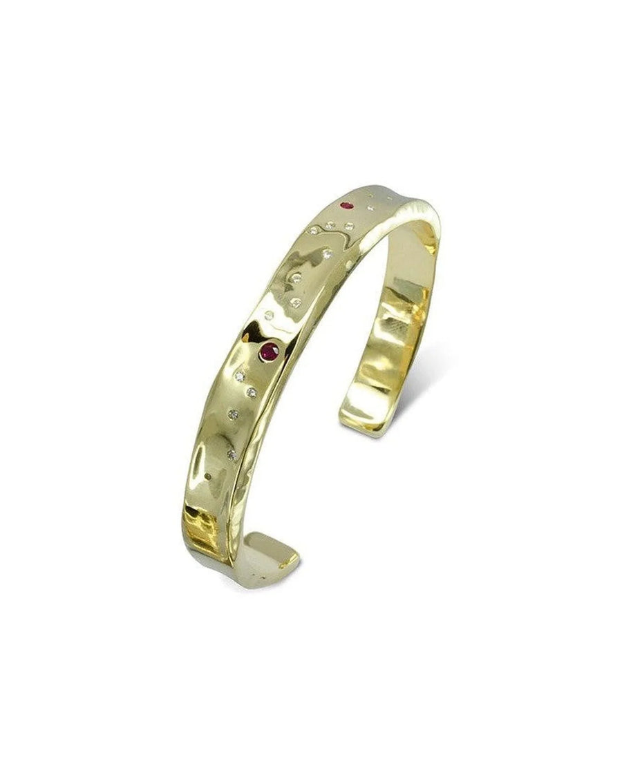 Hammered 9ct gold bangle set with rubies and diamonds, featuring a textured, organic design.