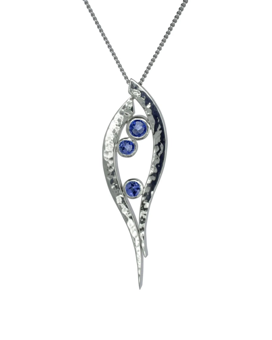 Handmade hammered silver pendant with three round blue tanzanite gemstones on a chain