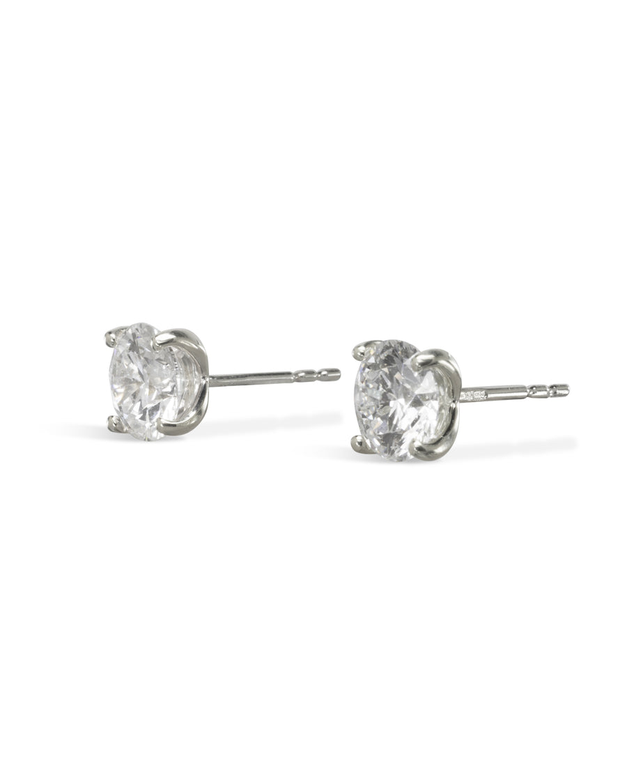 Silver four claw diamond stud earrings.