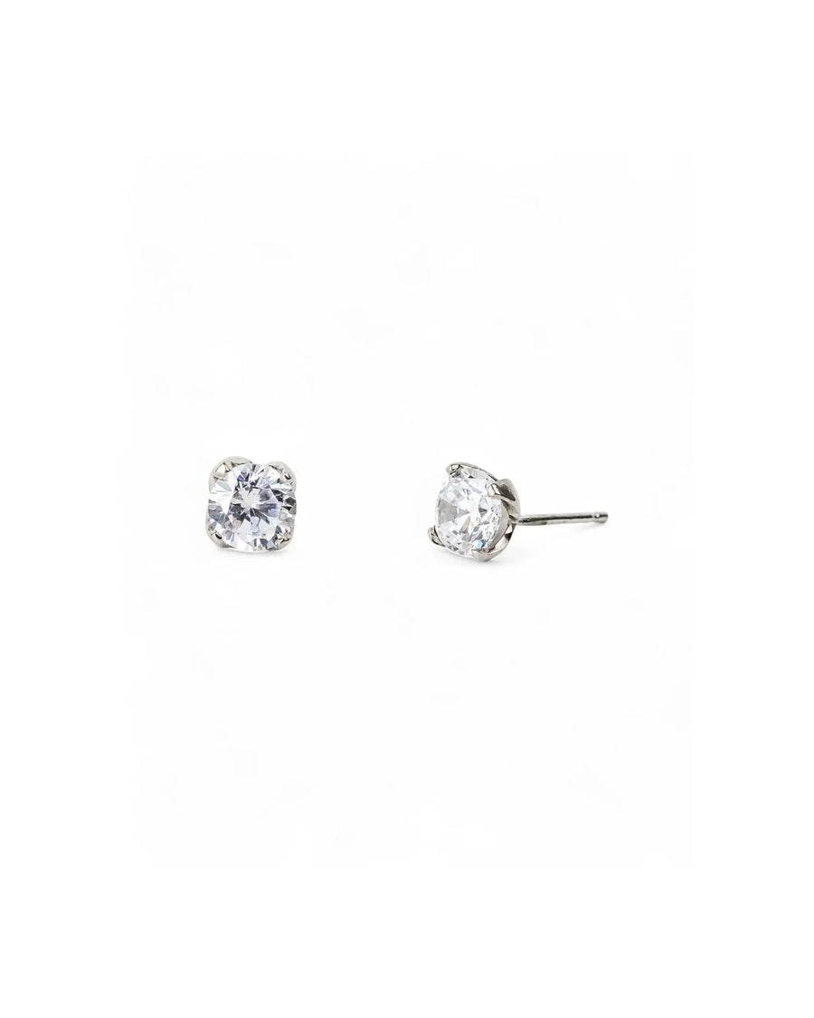 Silver four claw diamond stud earrings on a white background.