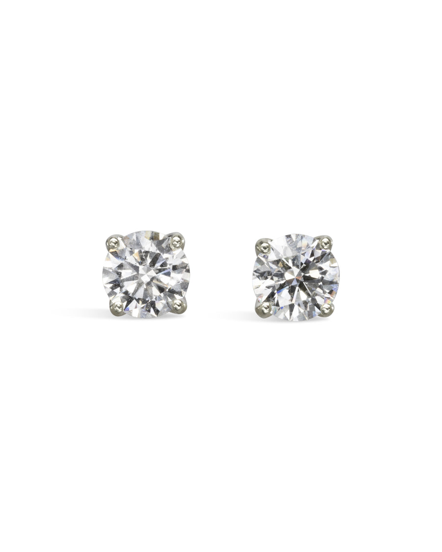 Silver four claw diamond stud earrings.