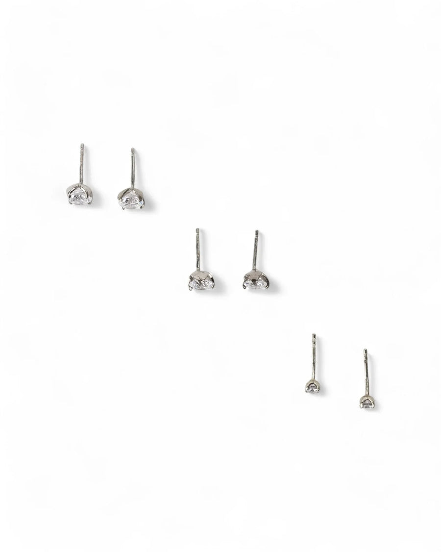 Silver four claw diamond stud earrings in three sizes.