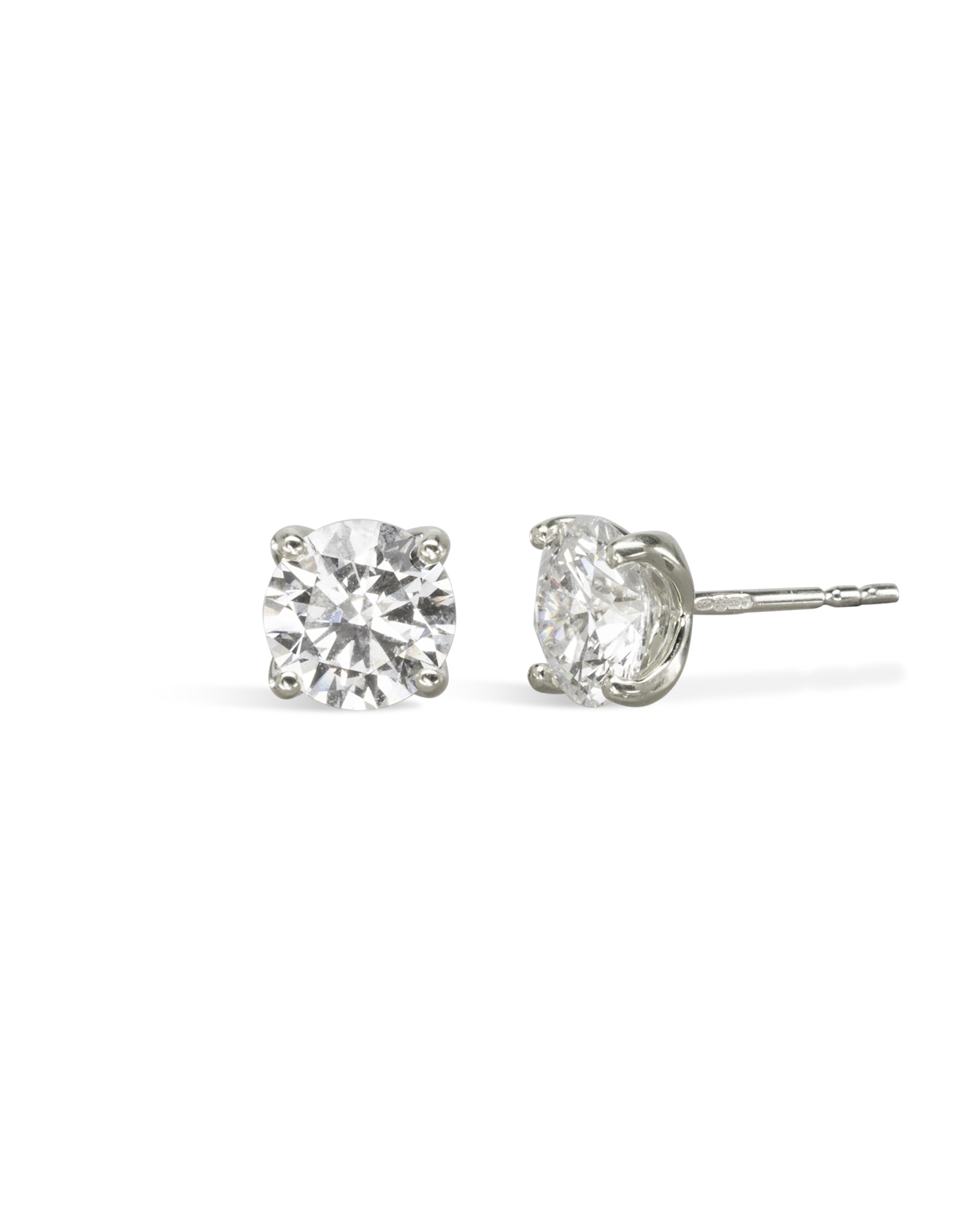 Pair of 9ct white gold four claw diamond stud earrings.