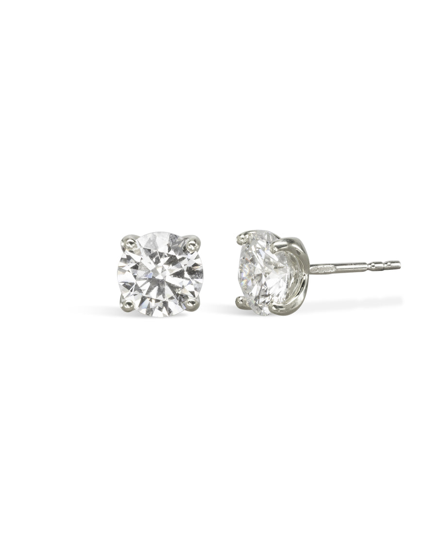 Pair of 9ct white gold four claw diamond stud earrings.