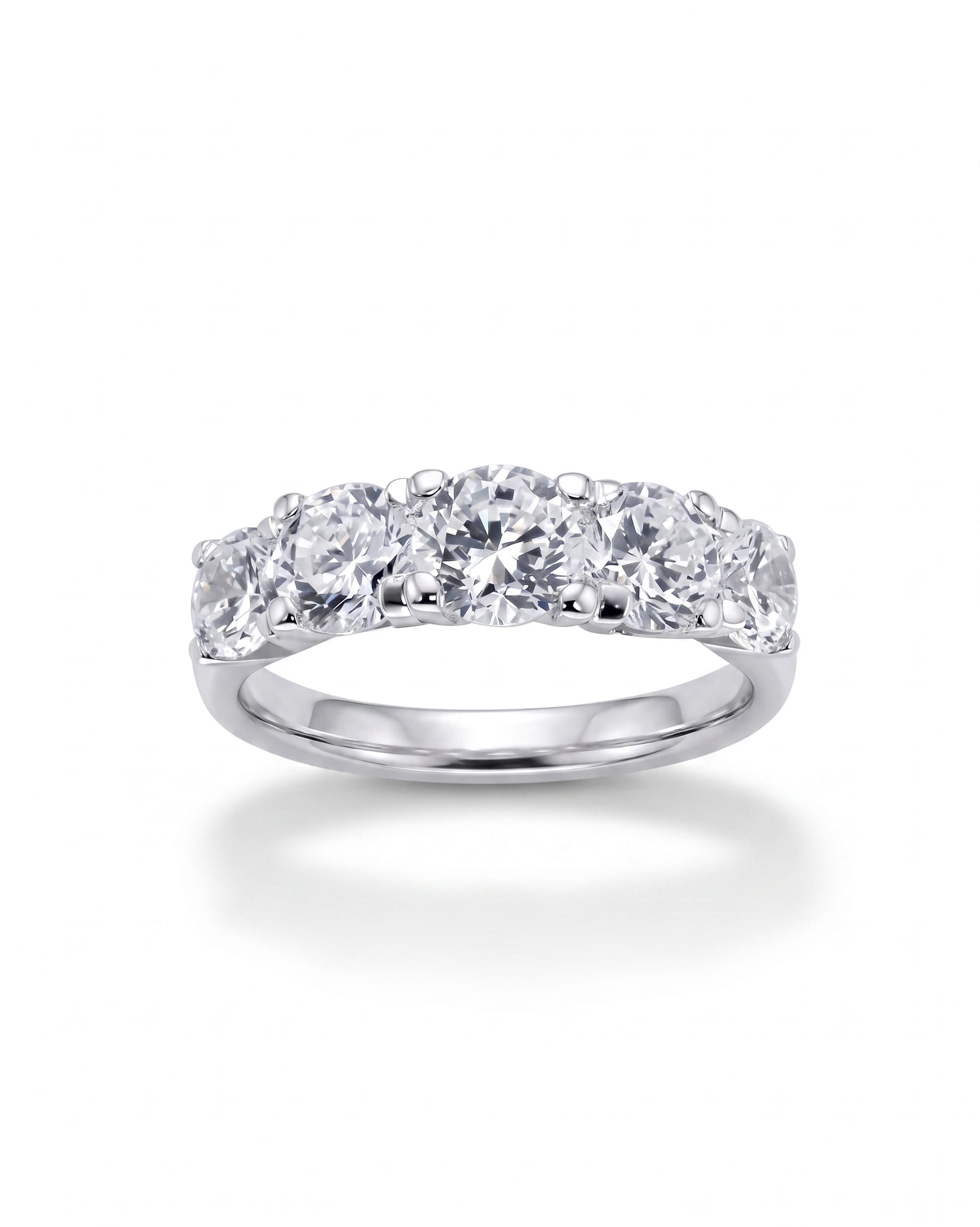 Silver half eternity ring with five round diamonds in four-claw settings.
