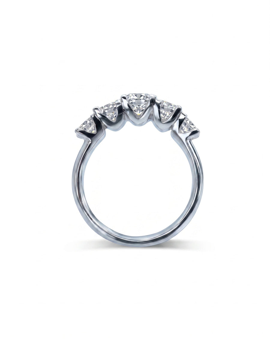 Silver half eternity ring with five round diamonds in four-claw settings.