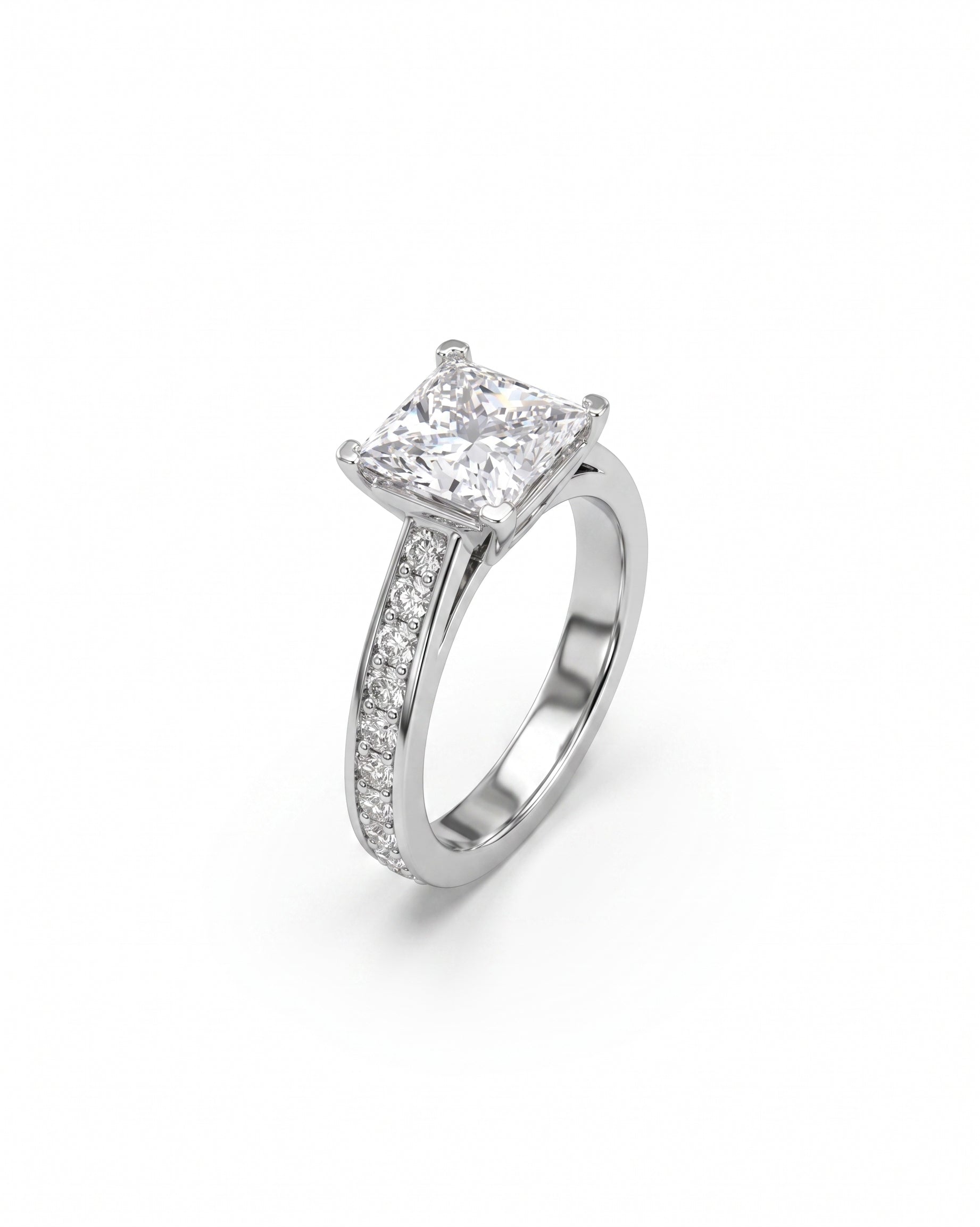 White gold engagement ring with a princess cut diamond and pavé set diamonds.