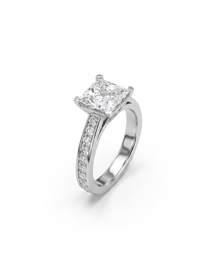 White gold engagement ring with a princess cut diamond and pavé set diamonds.