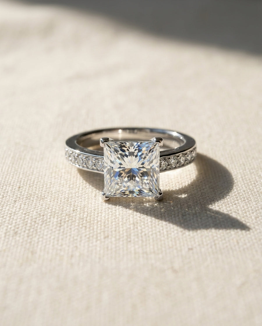 Platinum four claw pavé set princess cut diamond engagement ring.